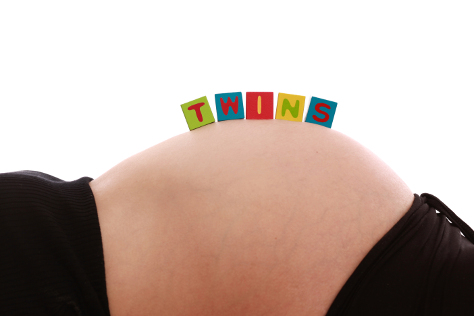 Woman laying down pregnant with twins
