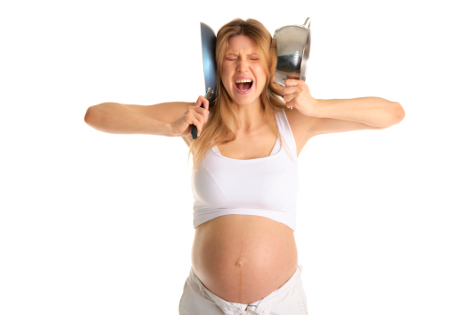 pregnant woman covering her ears