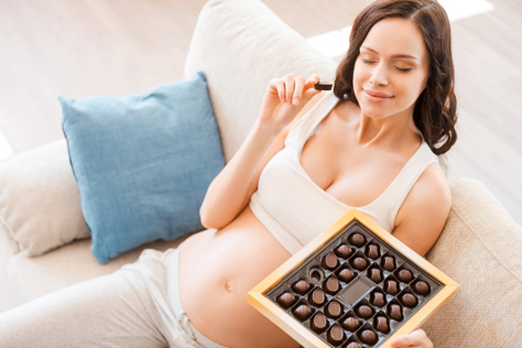 Pregnant woman eating chocolate