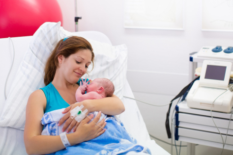 New mom after delivery holding her newborn